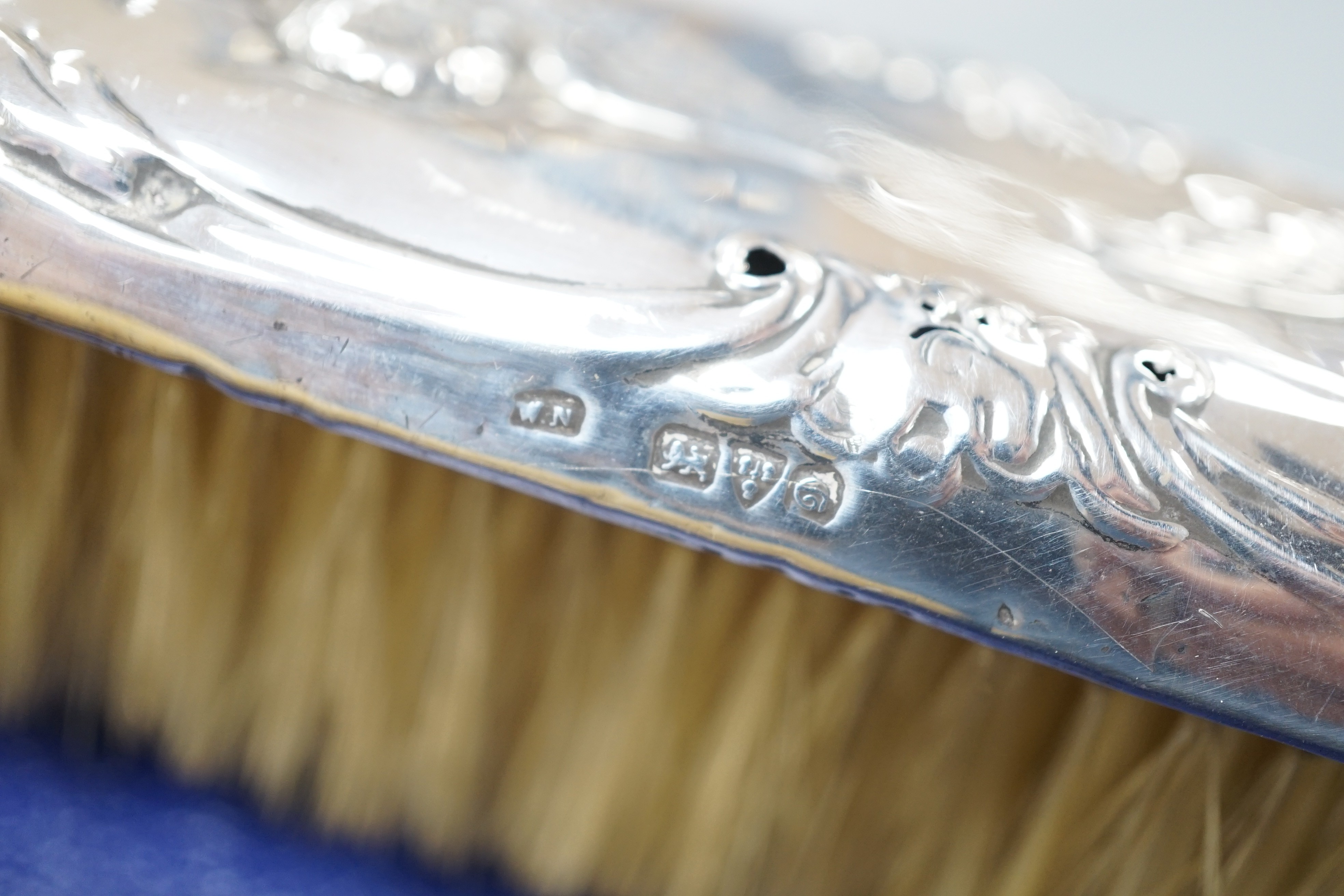 A cae 1970's engine turned silver mounted four piece mirror and brush set, two silver mounted hand mirrors and two silver mounted brushes.